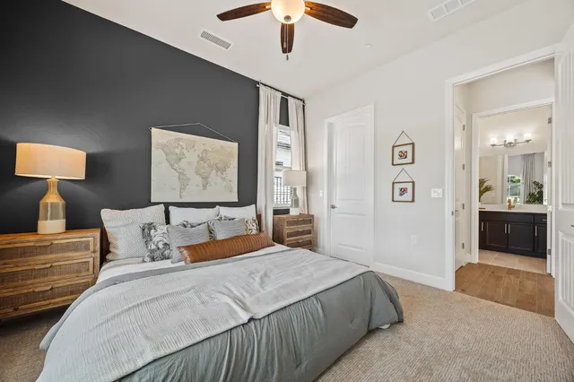 a bedroom with a large bed and a chandelier