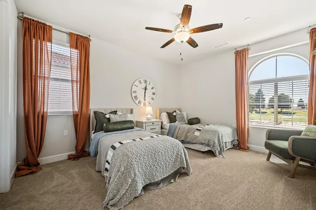 a bed room with two beds and a large window