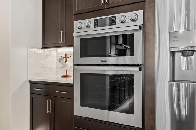 a stove top oven sitting inside of a kitchen