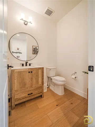 a bathroom with a toilet a mirror and a shower