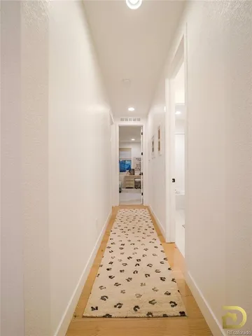 a view of hallway with wooden floor
