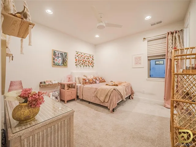 a bedroom with a bed and a couch