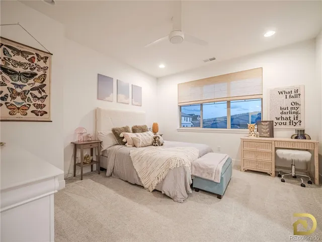 a bedroom with bed and a large window