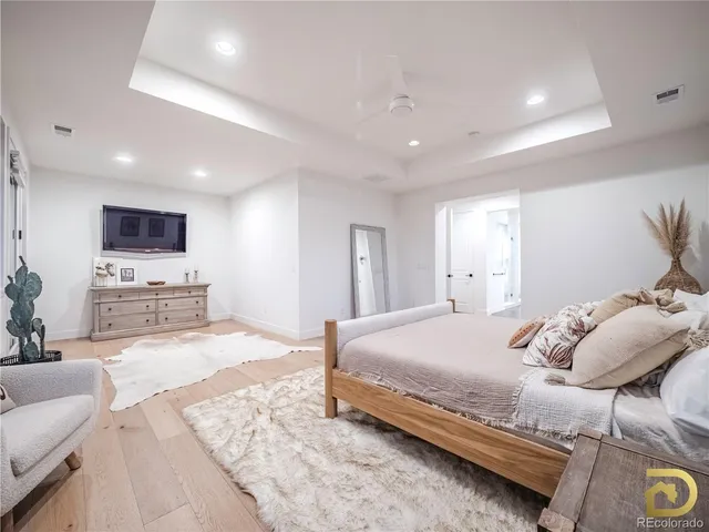 a spacious bedroom with a bed and a couch