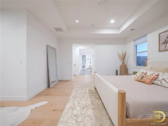 a large bedroom with a bed and lamp