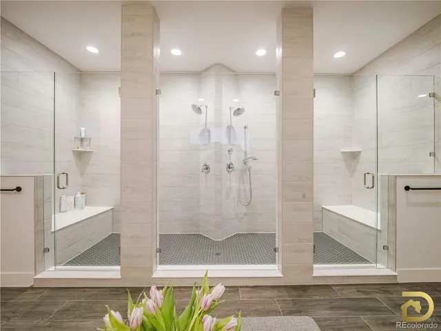 a bathroom with a glass shower door and a sink