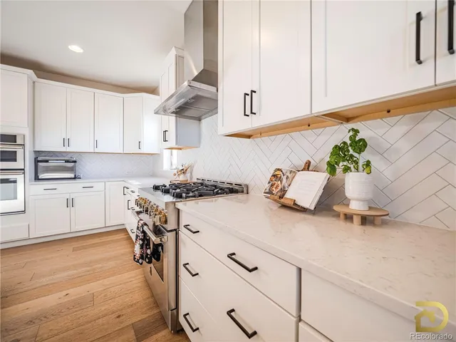 a kitchen with a sink cabinets and wooden floor