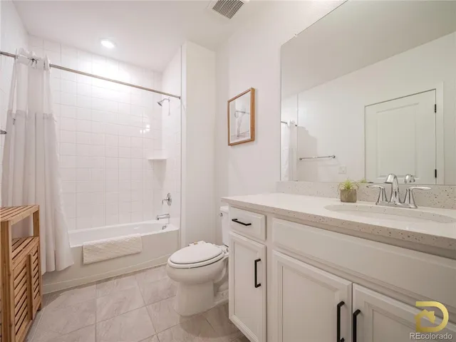 a spacious bathroom with a shower sink vanity mirror and toilet