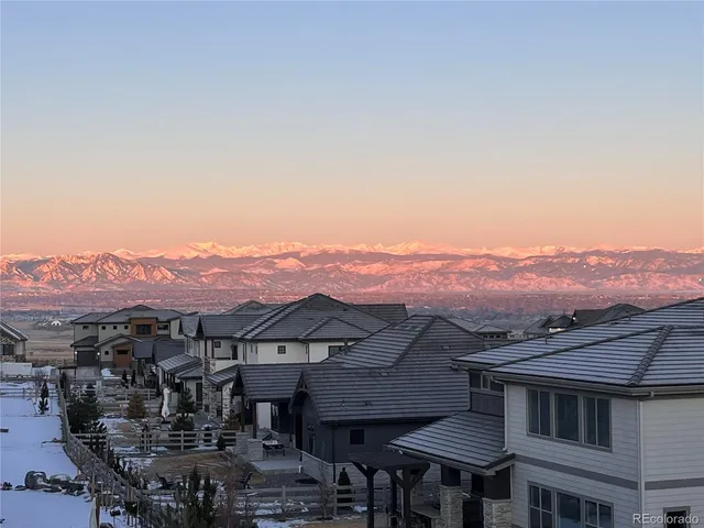 a view of a town with mountains in the background
