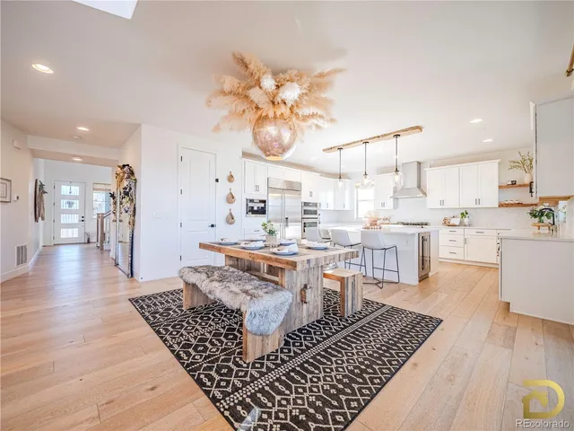 a living room with lots of furniture and kitchen view