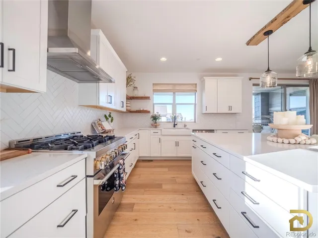 a kitchen with granite countertop a sink stove and cabinets