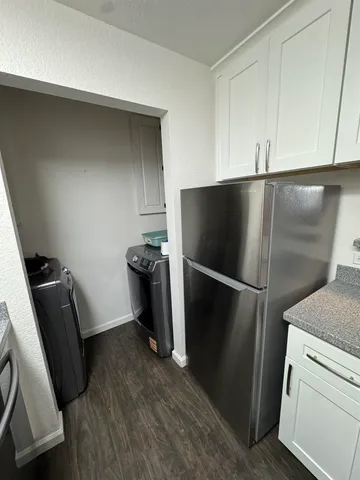 a kitchen with white cabinets and a sink