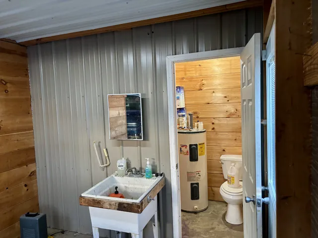 a bathroom with a sink a toilet and shower curtain