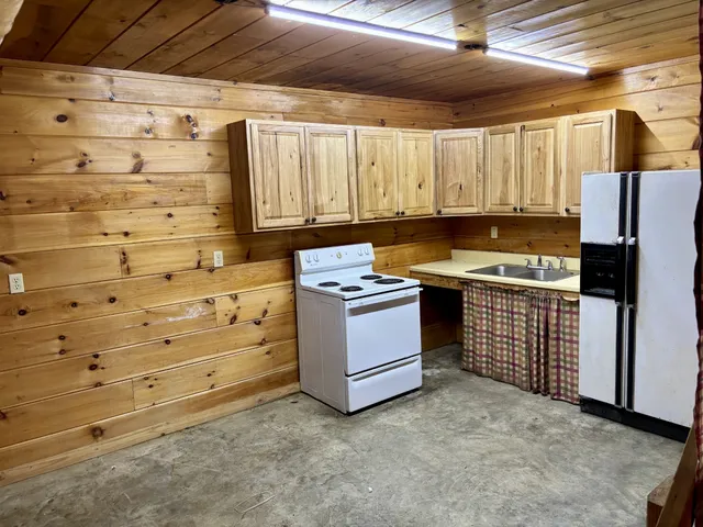 a kitchen with granite countertop white cabinets and stainless steel appliances