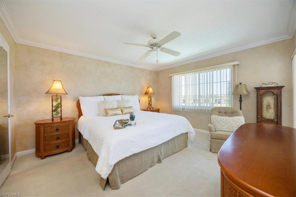 21 High Point Circle East, Unit 502 Naples, FL 34103 - Photo 12 of 24 a bedroom with bed and window