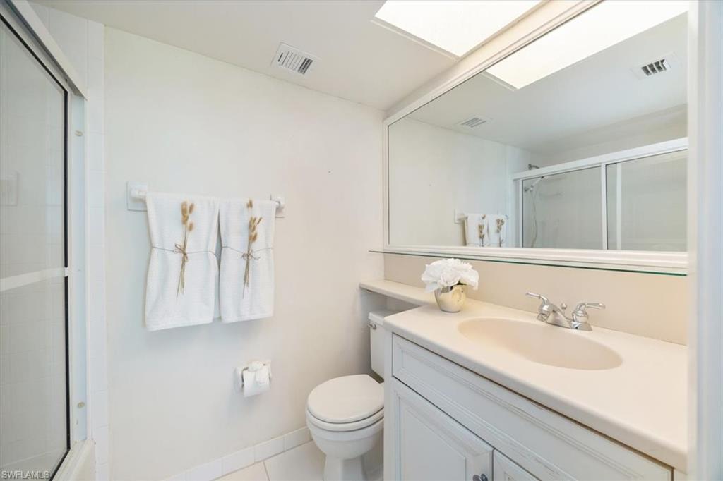 21 High Point Circle East, Unit 502 Naples, FL 34103 - Photo 15 of 24 a bathroom with a sink toilet and a mirror