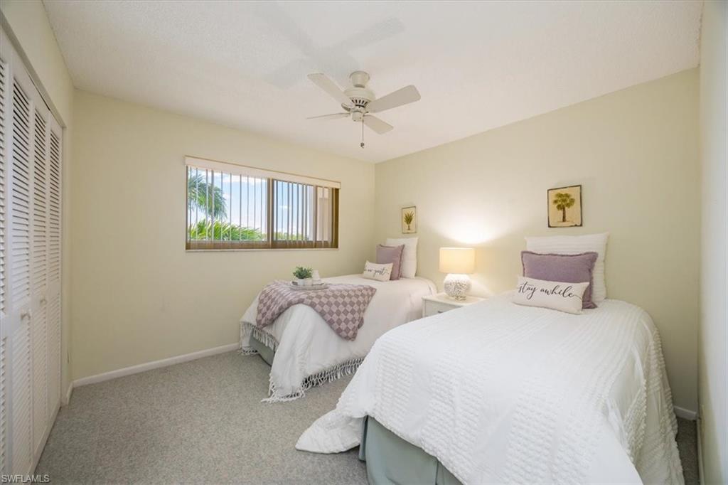 21 High Point Circle East, Unit 502 Naples, FL 34103 - Photo 17 of 24 a bedroom with two beds and painting on the wall