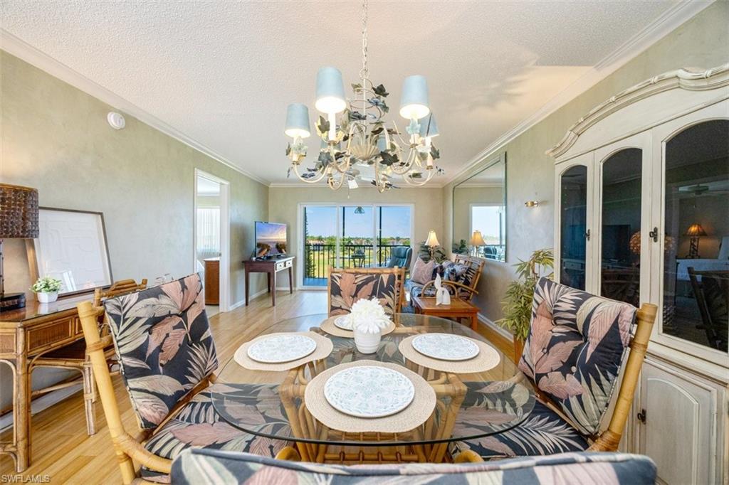 21 High Point Circle East, Unit 502 Naples, FL 34103 - Photo 3 of 24 a table and chairs in a dining room