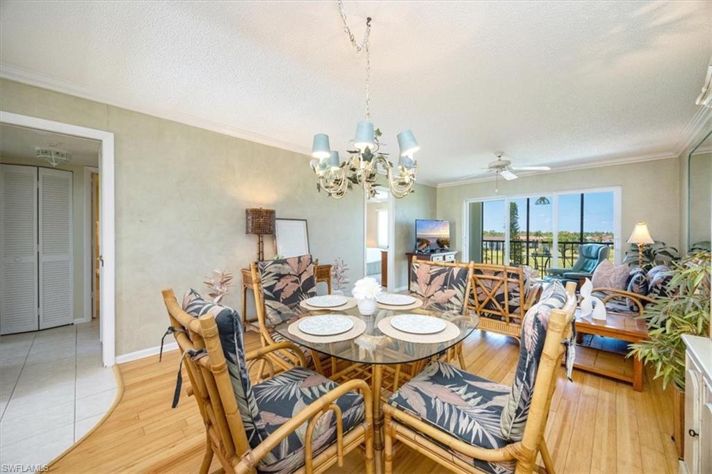21 High Point Circle East, Unit 502 Naples, FL 34103 - Photo 4 of 24 a view of a dining room with furniture and chandelier