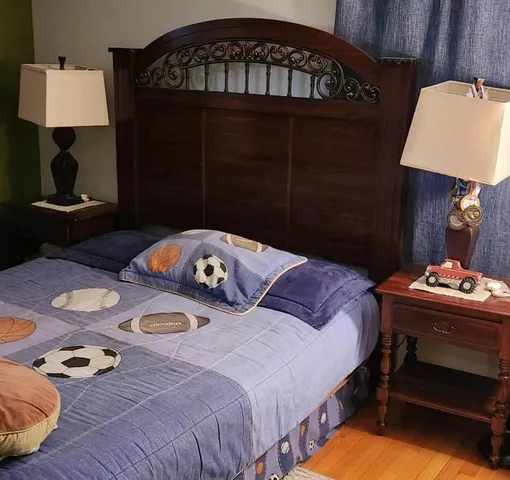 a bedroom that has a bed and a table in it