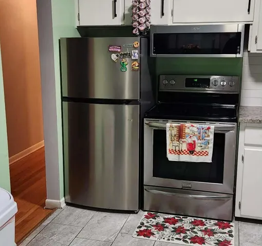 a refrigerator freezer sitting inside of a kitchen