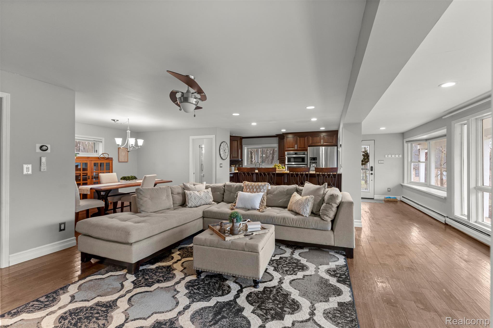 45401 West 9 Mile Road Novi, MI 48374 - Photo 8 of 67 Living area featuring a baseboard heating unit, recessed lighting, wood-type flooring, and a chandelier
