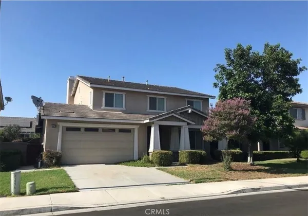 a house that has a tree in front of it