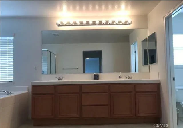 a bathroom with a double vanity sink and a mirror