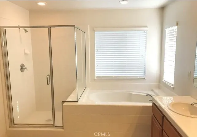 a bathroom with a bathtub and a shower