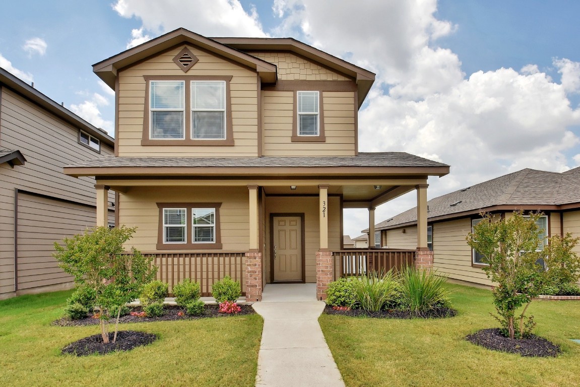 a front view of a house with garden