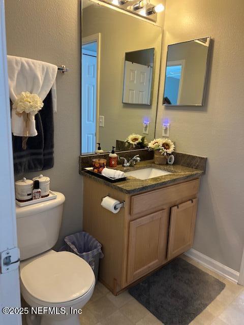 385 Scrub Jay Drive St. Augustine, FL 32092 - Photo 12 of 16 a bathroom with a toilet sink and mirror