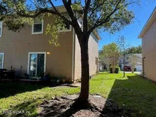 a view of a sign board with buildings in the background