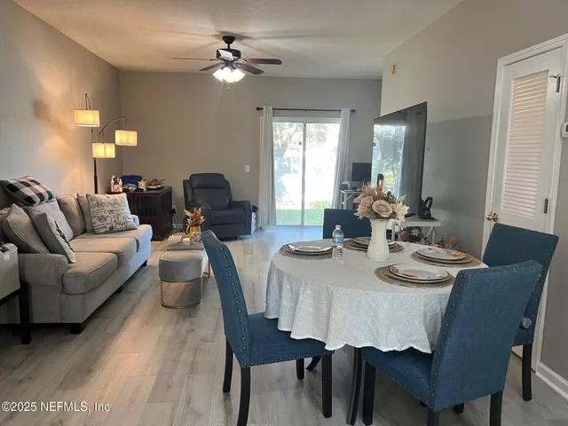 a view of a dining room with furniture and wooden floor