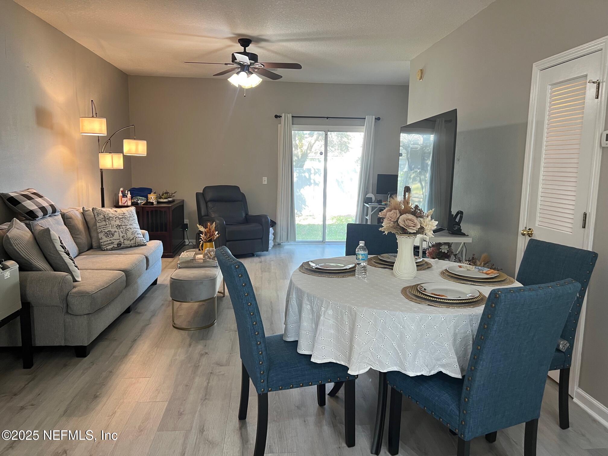 385 Scrub Jay Drive St. Augustine, FL 32092 - Photo 3 of 16 a view of a dining room with furniture and wooden floor