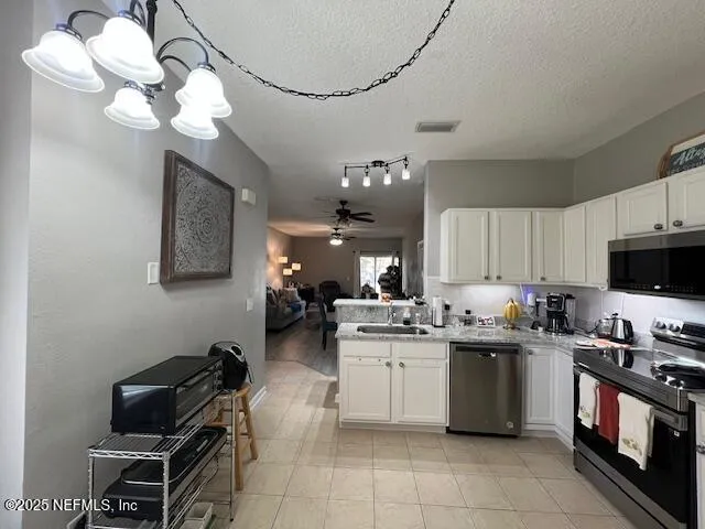 a kitchen with a sink a stove and cabinets