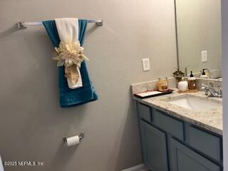 385 Scrub Jay Drive St. Augustine, FL 32092 - Photo 7 of 16 a bathroom with a granite countertop sink a toilet and mirror