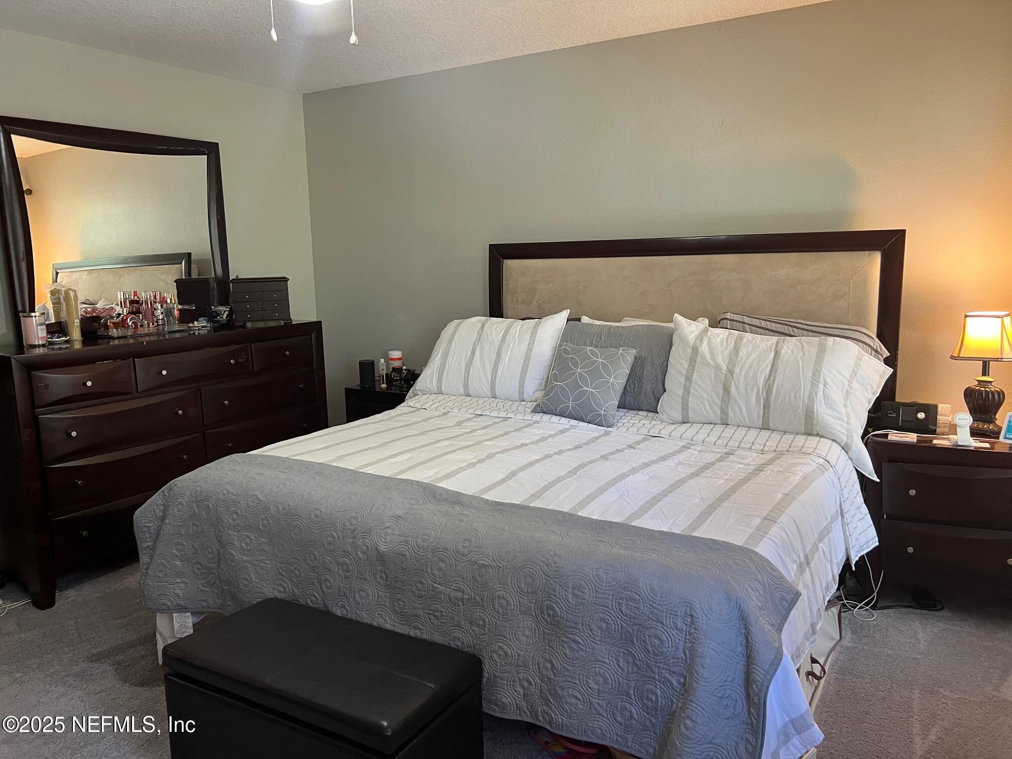 385 Scrub Jay Drive St. Augustine, FL 32092 - Photo 8 of 16 a bedroom with a bed and a dresser