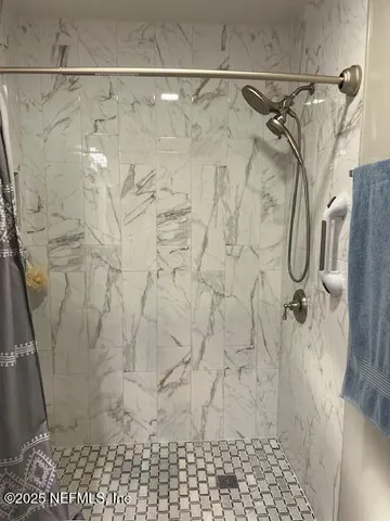 a bedroom with a bed a desk and chair