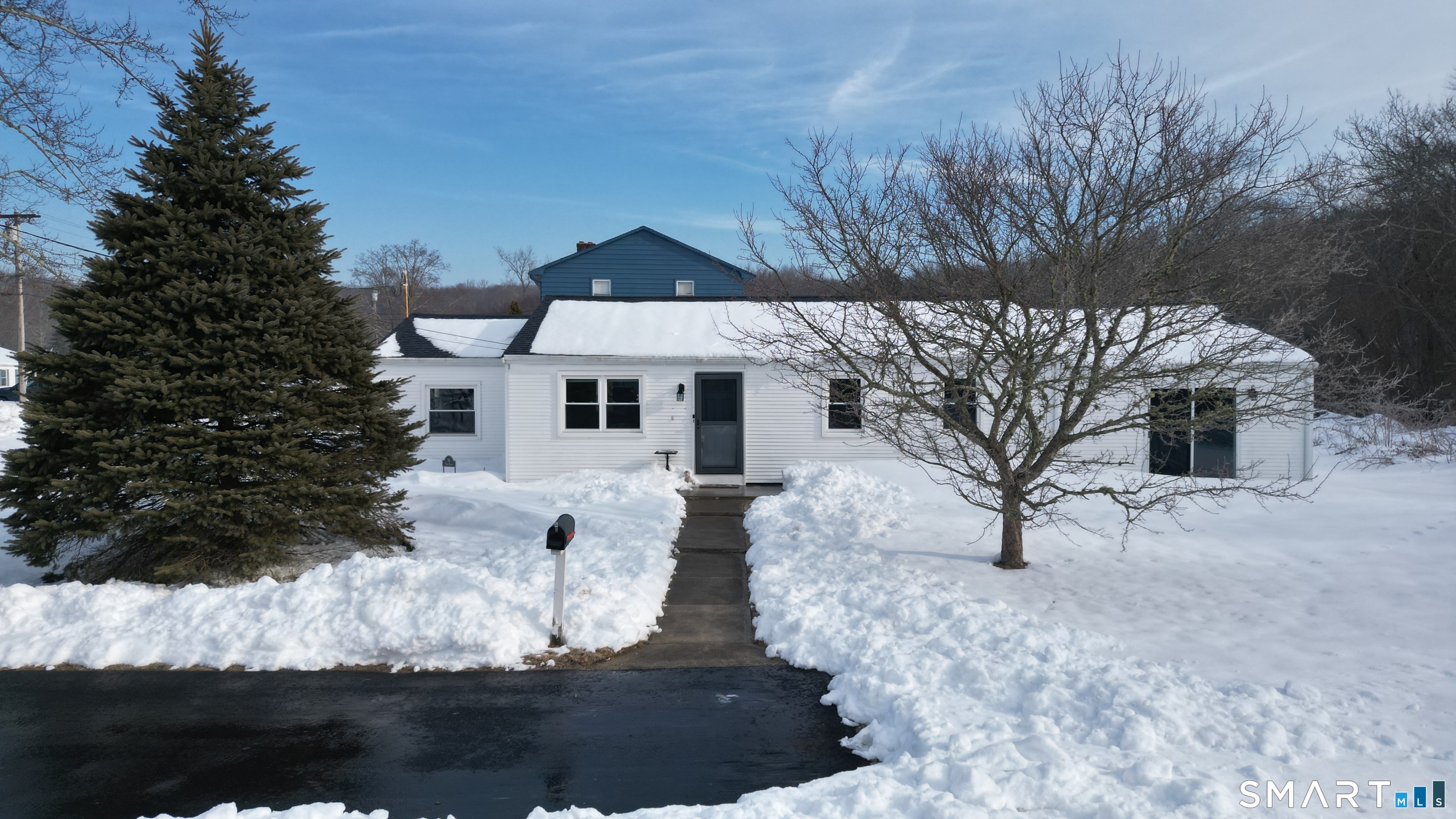 96 Ring Drive Groton, CT 06340 - Photo 1 of 1 a front view of a house with a yard covered with snow
