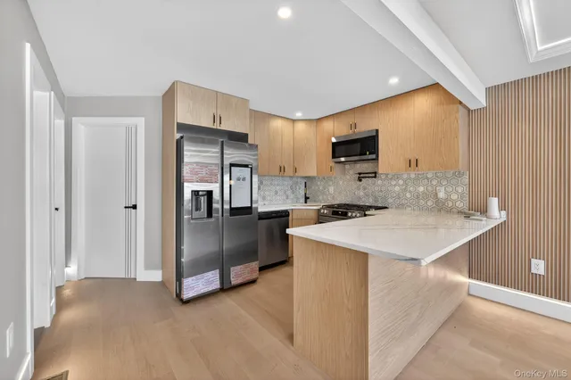 a kitchen that has a sink and a stove in it