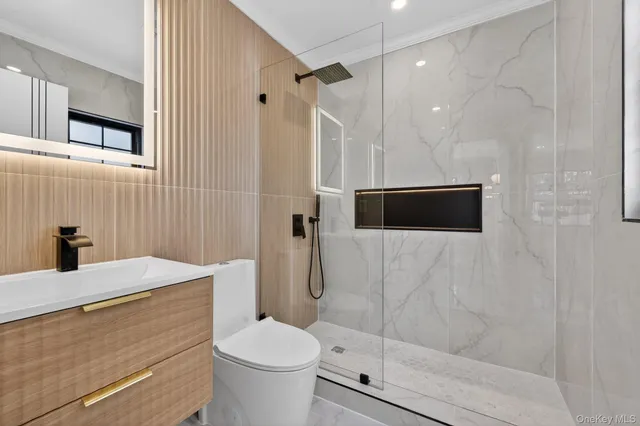 a bathroom with a shower toilet and sink