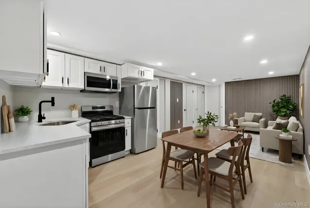 a kitchen with kitchen island a refrigerator stove and microwave