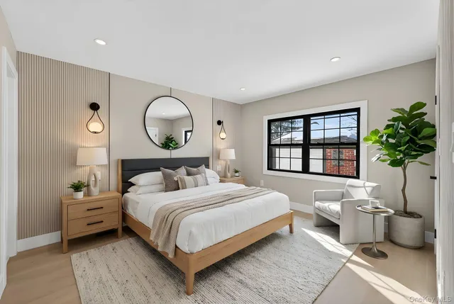 a bedroom with a large bed and a window