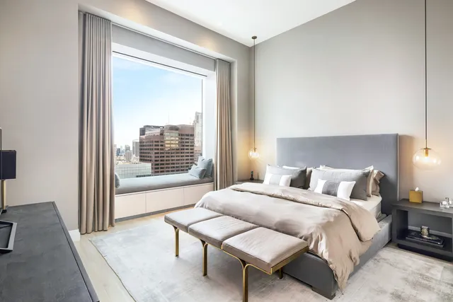 a living room with furniture and a floor to ceiling window