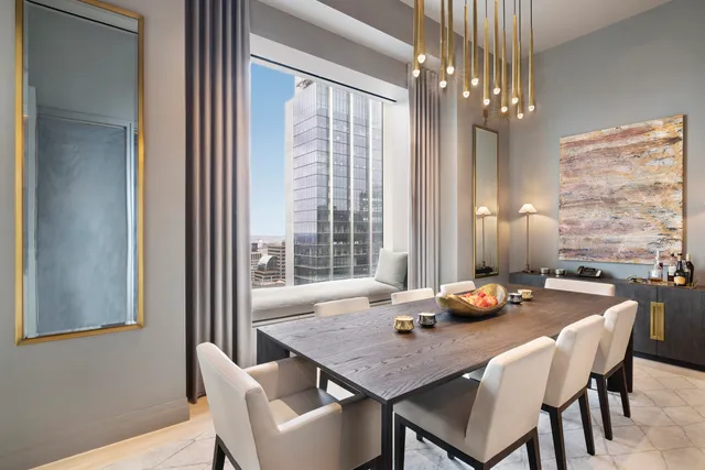 a living room with furniture a table and a chandelier