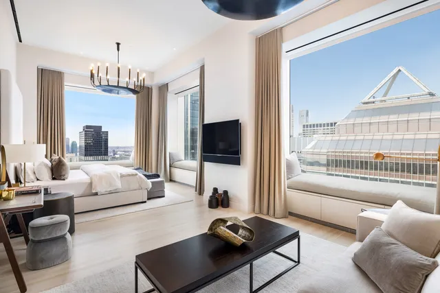 a view of living room filled with furniture and a chandelier