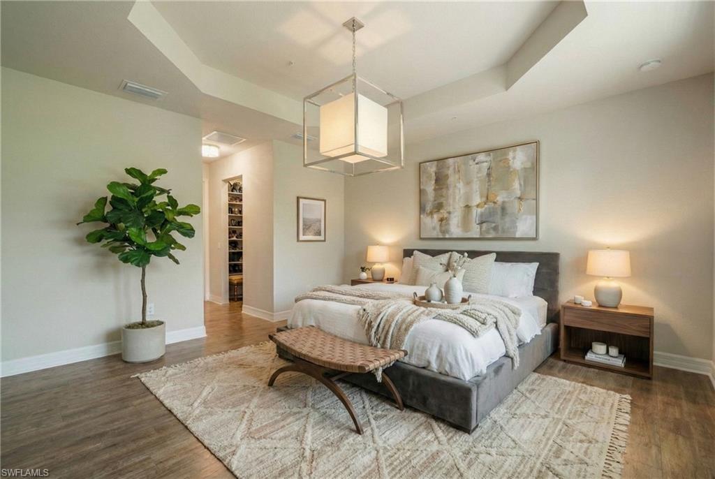 6510 Monterey Point, Unit 204 Naples, FL 34105 - Photo 13 of 48 a bedroom with a bed and a potted plant