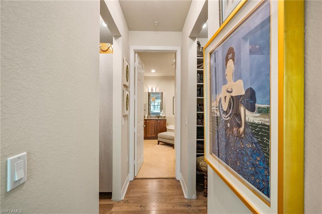 6510 Monterey Point, Unit 204 Naples, FL 34105 - Photo 14 of 48 a view of a hallway with wooden floor and a living room