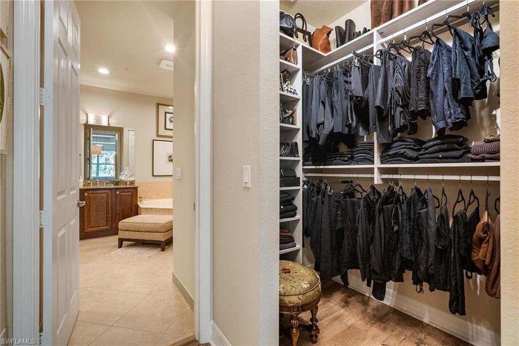 6510 Monterey Point, Unit 204 Naples, FL 34105 - Photo 16 of 48 a view of walk in closet with clothes and shoes