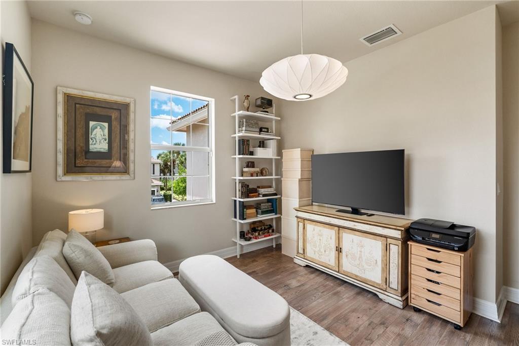 6510 Monterey Point, Unit 204 Naples, FL 34105 - Photo 26 of 48 a living room with furniture and a flat screen tv